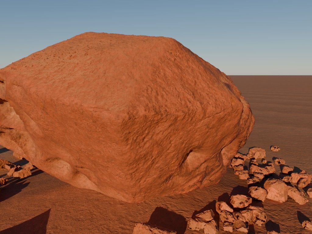 A weathered red boulder with scattered rubble